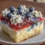red white and blue layered jello poke cake - featured image
